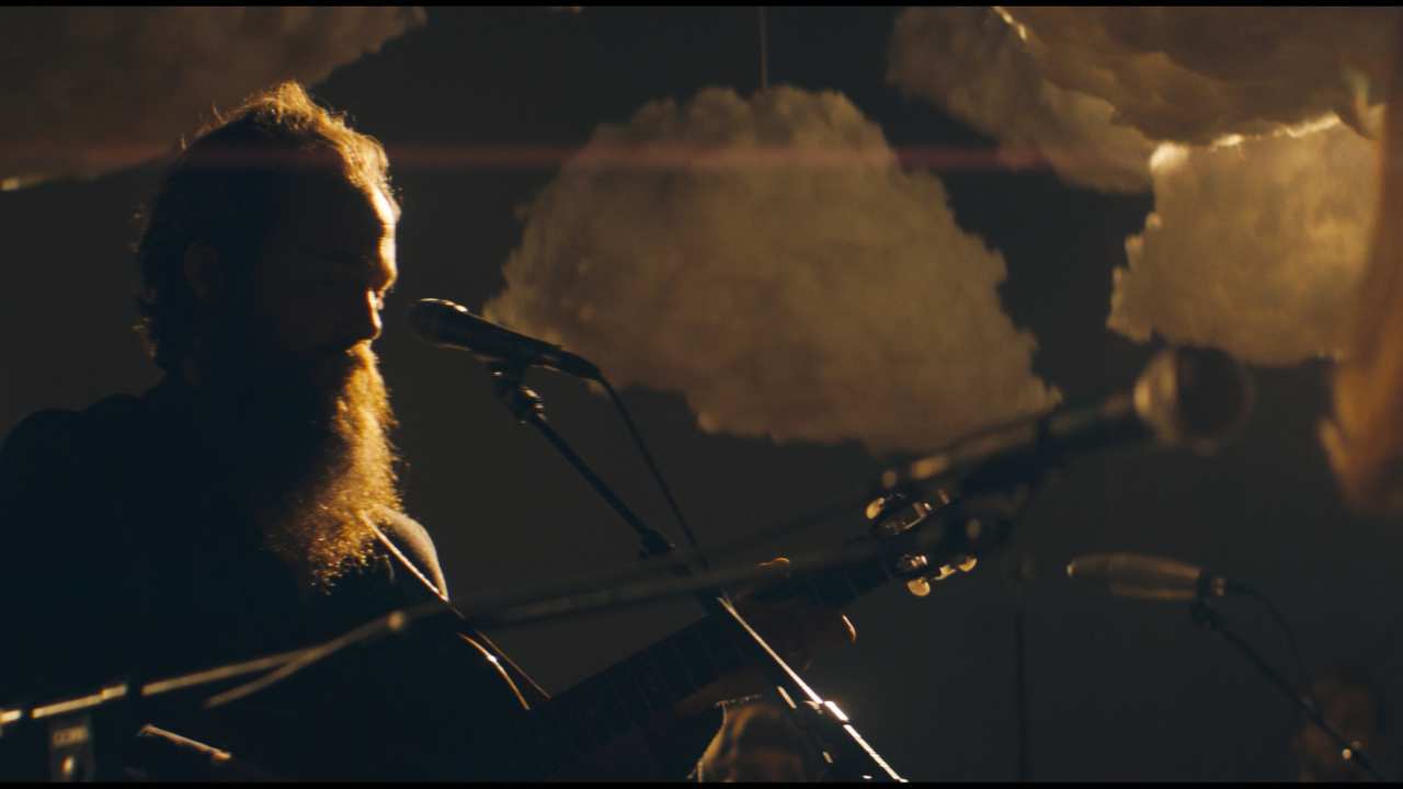 a man with a beard playing music